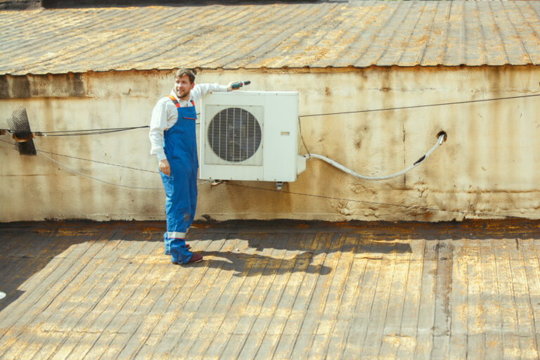 HVAC technician servicing an outdoor air conditioning condenser unit at an Arizona home.